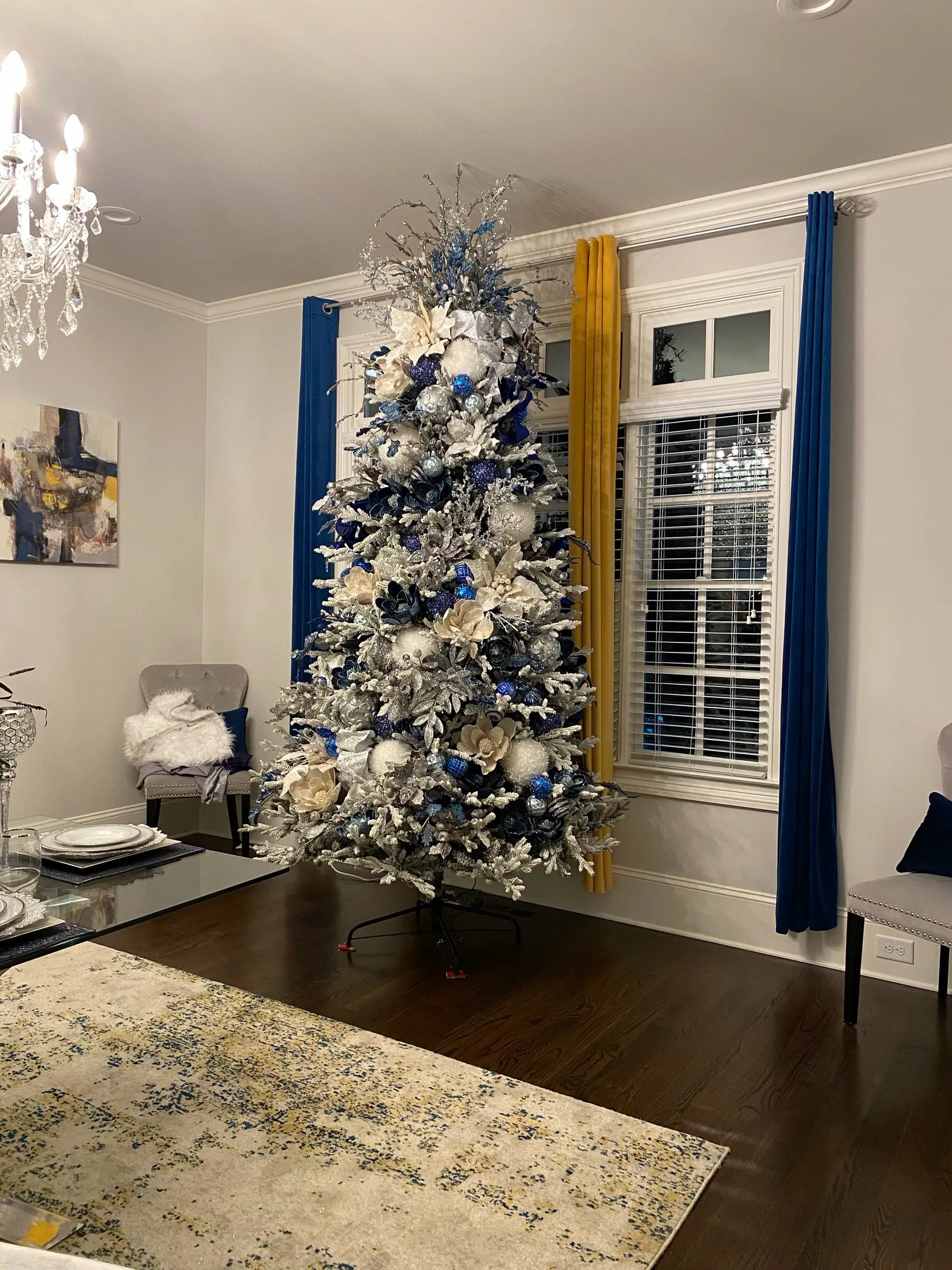A real Christmas tree decorated with blue and silver ornaments
