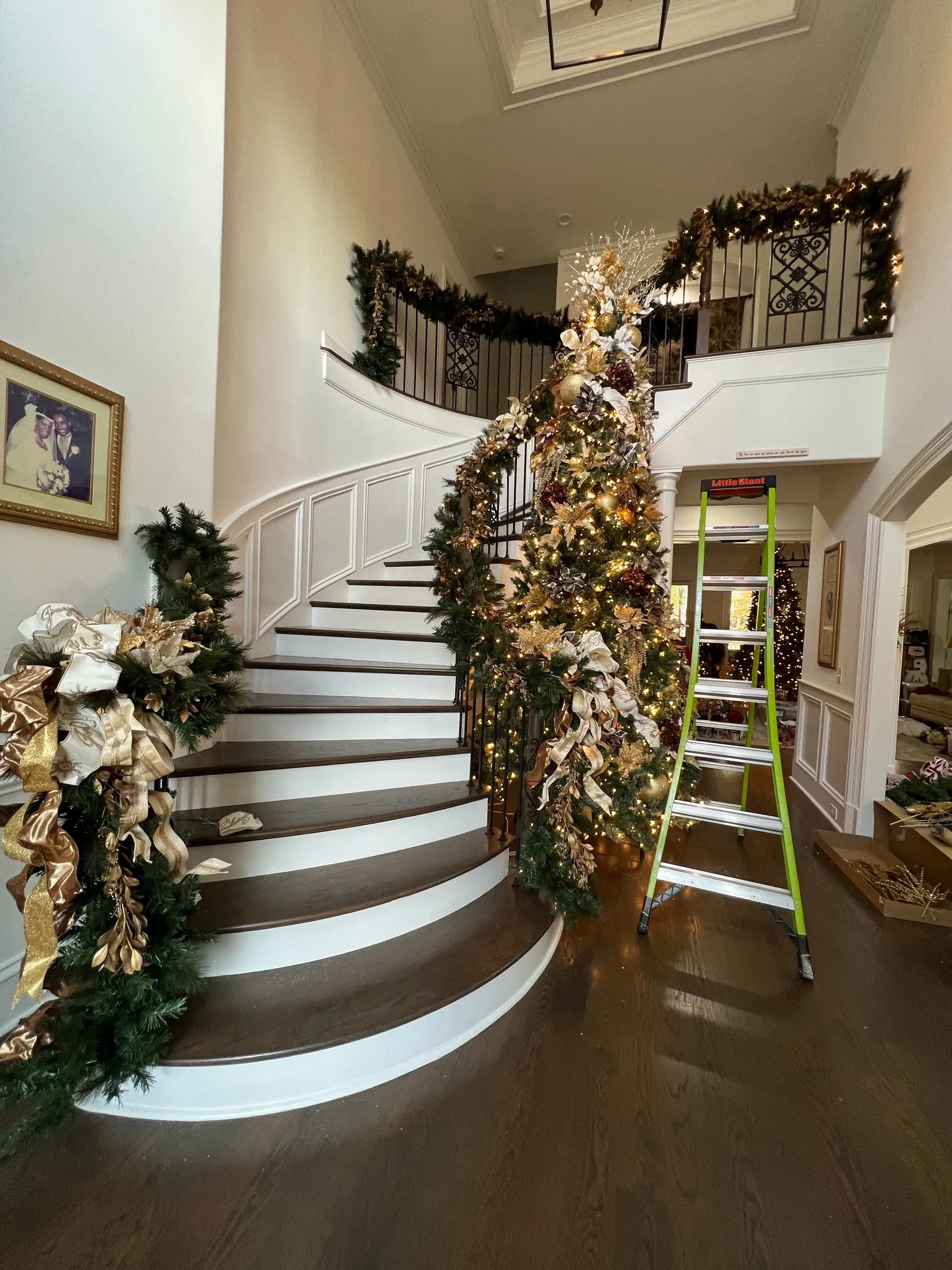 A real staircase decorated with Christmas garland and ornaments