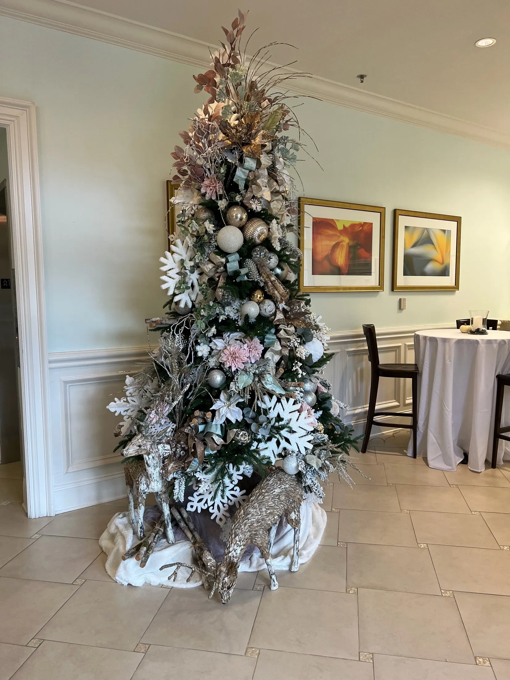 A real white, blush, and frosted Christmas tree installation